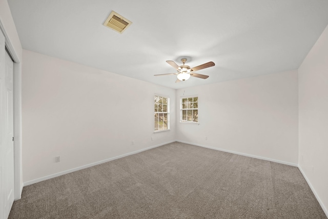 unfurnished room with ceiling fan and carpet floors