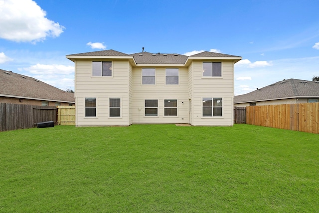 rear view of house with a lawn