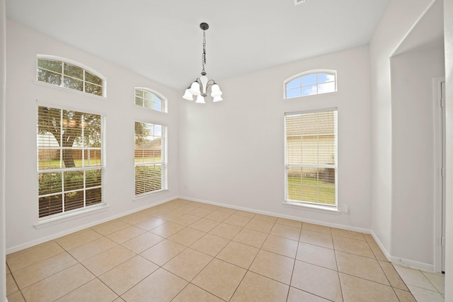 unfurnished dining area with an inviting chandelier and light tile patterned flooring