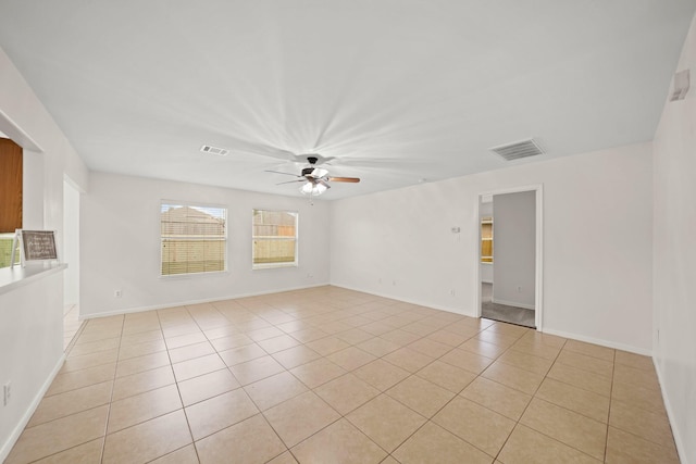 tiled spare room with ceiling fan