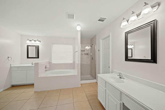 bathroom featuring tile patterned floors, vanity, and plus walk in shower