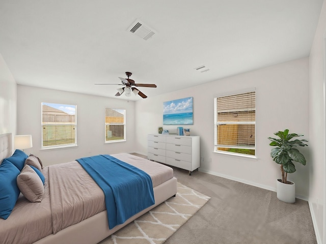 bedroom with ceiling fan and light carpet