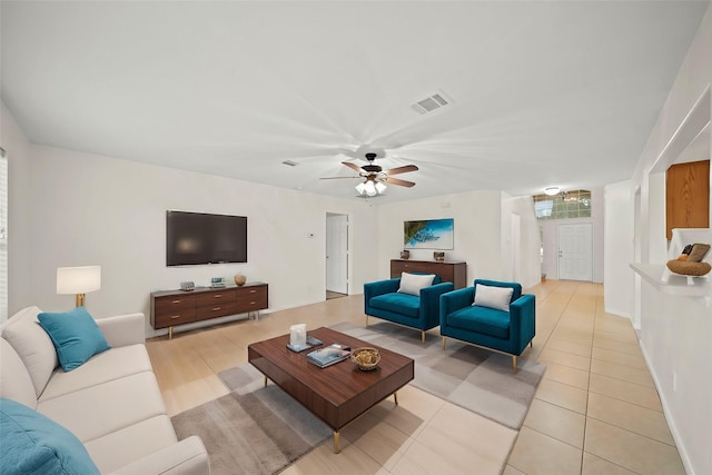 tiled living room featuring ceiling fan