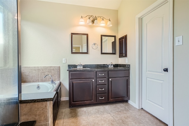 bathroom featuring vanity, tiled bath, and tile patterned flooring