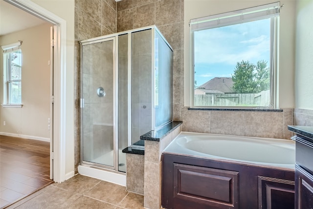 bathroom with shower with separate bathtub and tile patterned floors