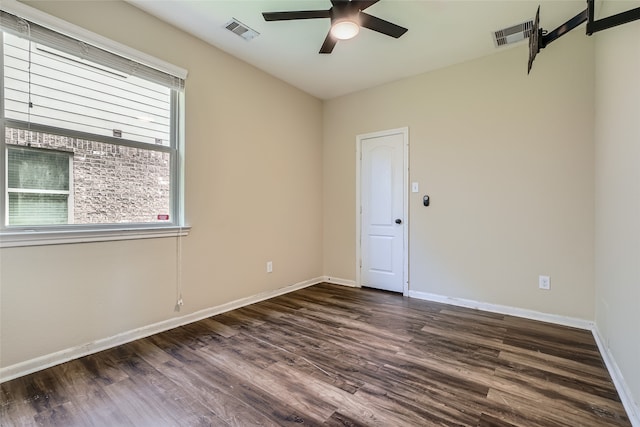 empty room featuring ceiling fan and dark hardwood / wood-style floors