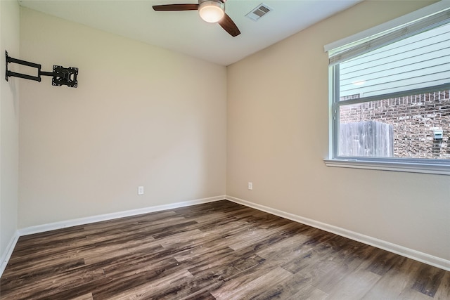 unfurnished room with ceiling fan and dark hardwood / wood-style flooring