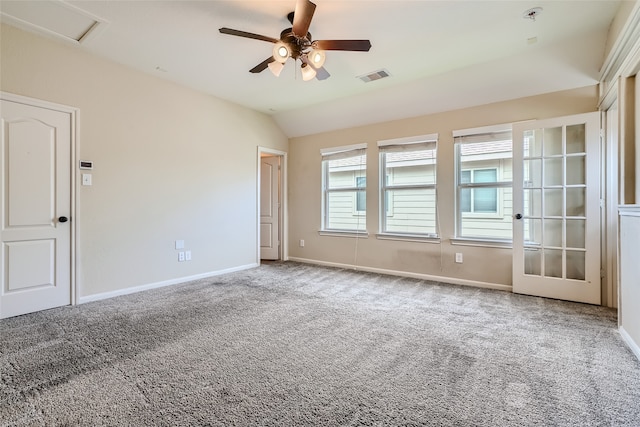 carpeted empty room with vaulted ceiling and ceiling fan