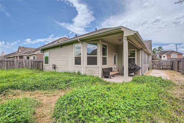 rear view of house featuring a patio