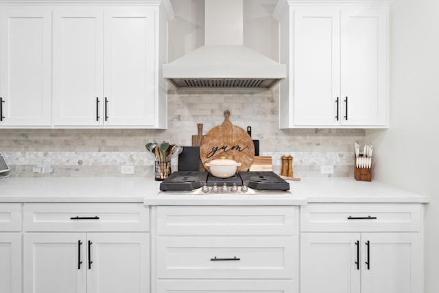 kitchen with premium range hood, backsplash, and white cabinetry