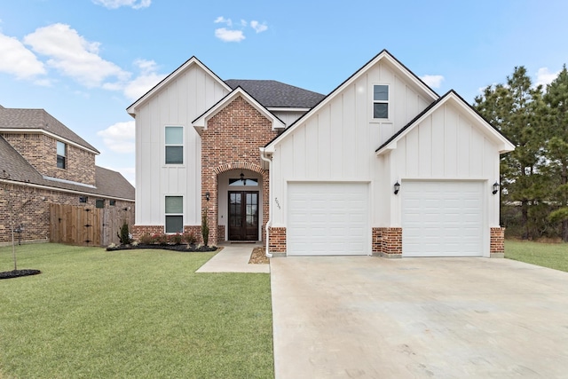 view of front of home featuring a garage, a front lawn, and french doors