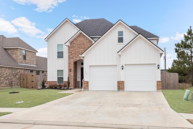 view of front of house with a garage and a front lawn