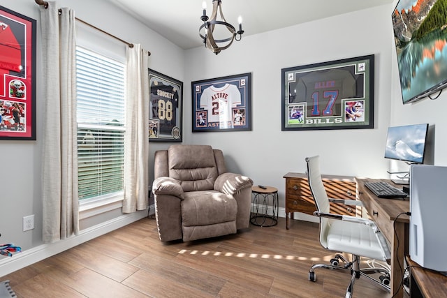 office space with a chandelier, a healthy amount of sunlight, and hardwood / wood-style floors