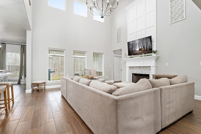 living room with a notable chandelier, a towering ceiling, and a wealth of natural light