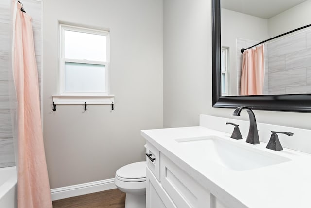 full bathroom with wood-type flooring, toilet, shower / tub combo with curtain, and vanity