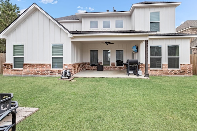 back of house featuring a patio area, a lawn, and ceiling fan