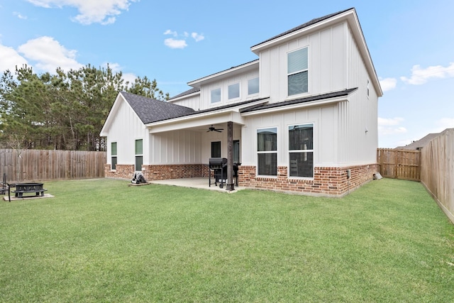 rear view of house with a patio area, a yard, and ceiling fan