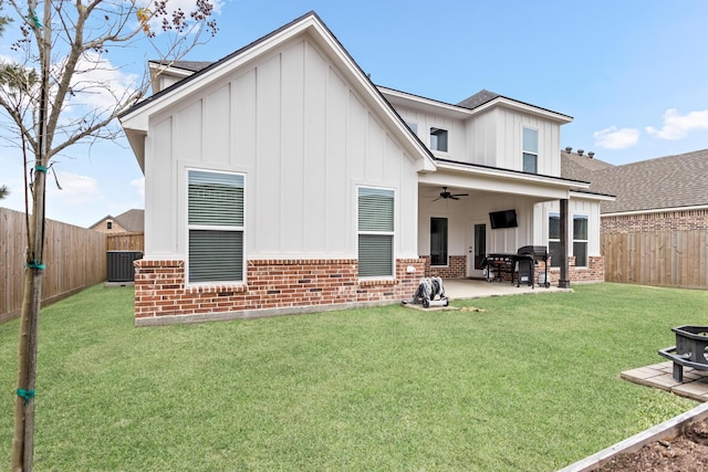 back of property featuring ceiling fan, a patio area, central AC unit, and a yard