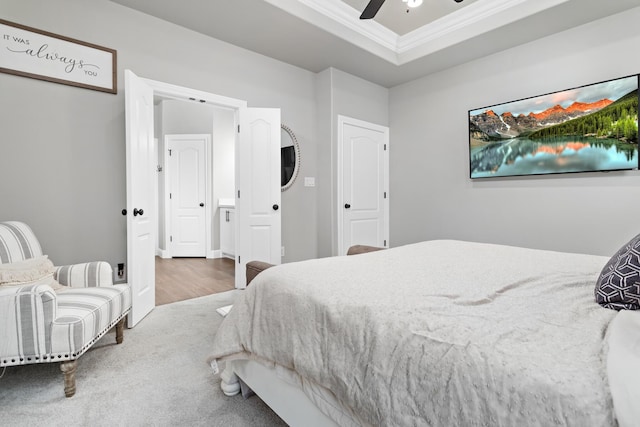 bedroom featuring ceiling fan, a raised ceiling, and crown molding