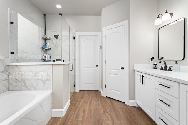 bathroom with independent shower and bath and vanity