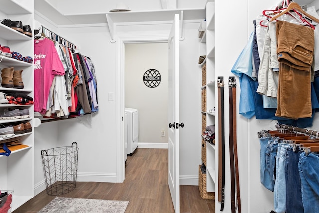 spacious closet with hardwood / wood-style floors and washer and dryer