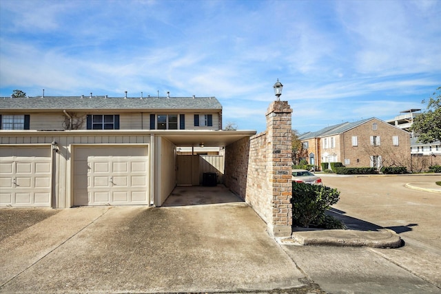 townhome / multi-family property with a garage, concrete driveway, and board and batten siding