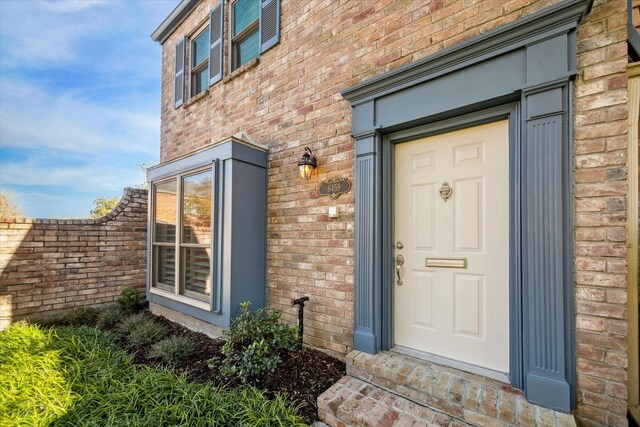 entrance to property with brick siding