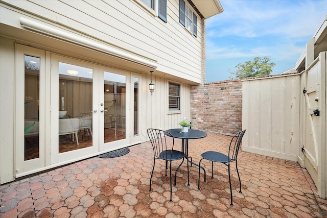 view of patio / terrace featuring fence and french doors