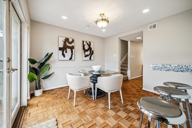 dining space with recessed lighting, visible vents, baseboards, and stairs