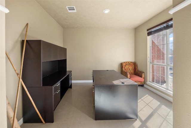 office area with light tile patterned floors and a healthy amount of sunlight