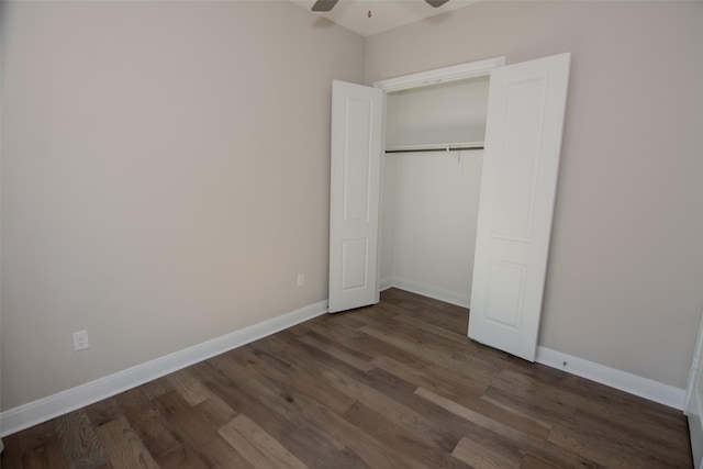 unfurnished bedroom featuring ceiling fan, a closet, and dark hardwood / wood-style flooring