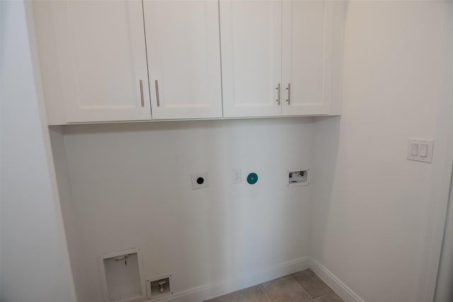 clothes washing area featuring hookup for an electric dryer, cabinets, washer hookup, and light tile patterned flooring