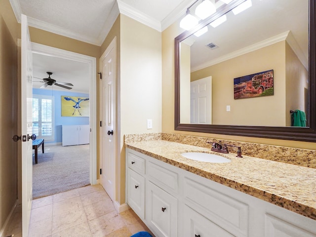 bathroom with crown molding, ceiling fan, and vanity