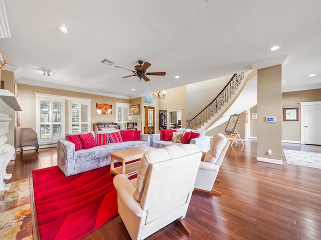 living room featuring ceiling fan with notable chandelier, dark hardwood / wood-style flooring, and crown molding