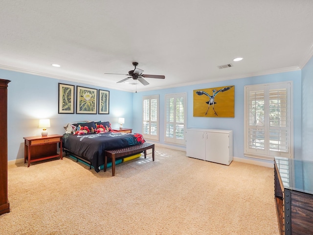 carpeted bedroom with ceiling fan and ornamental molding