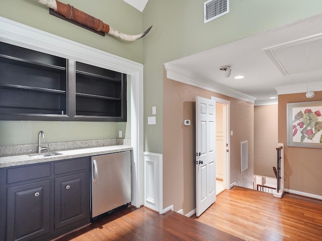 bar featuring refrigerator, crown molding, light hardwood / wood-style floors, sink, and light stone counters