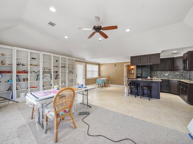 dining space with vaulted ceiling and ceiling fan