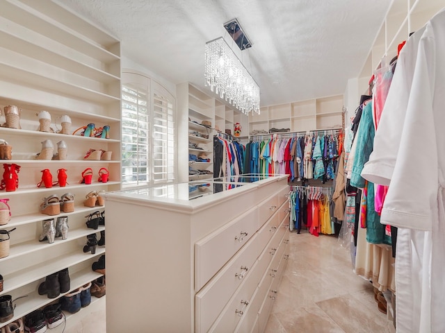 spacious closet with a notable chandelier