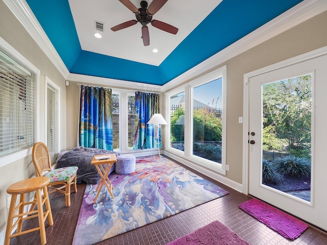 sunroom with ceiling fan and lofted ceiling