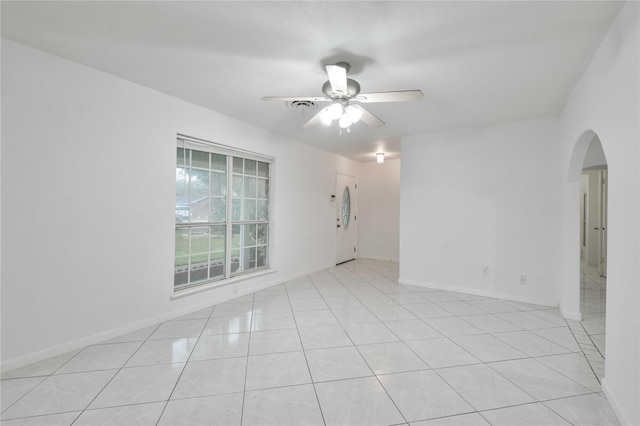 spare room featuring light tile patterned floors and ceiling fan