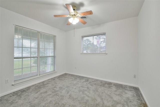 spare room with ceiling fan and light carpet