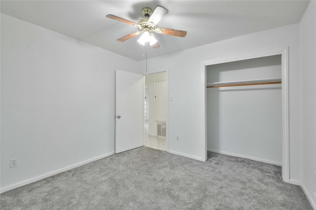 unfurnished bedroom featuring light carpet, a closet, and ceiling fan