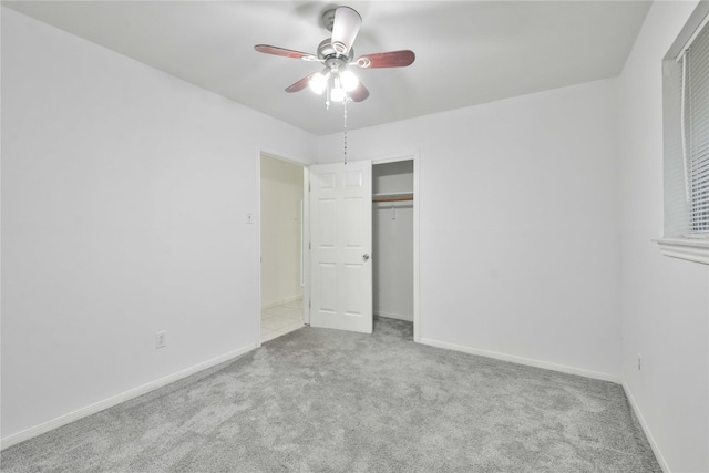 unfurnished bedroom featuring a closet, ceiling fan, and light colored carpet