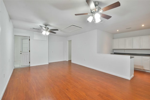 unfurnished living room with ceiling fan and light hardwood / wood-style flooring