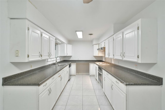 kitchen with sink, stainless steel appliances, white cabinetry, and light tile patterned floors