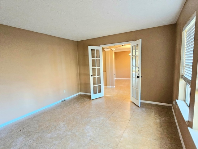 spare room featuring french doors