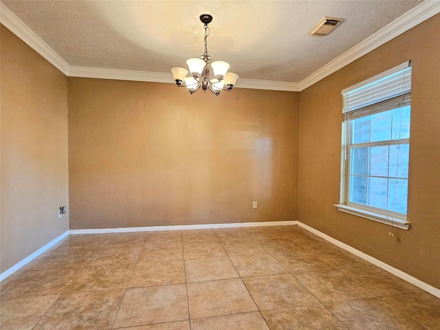 tiled spare room with a textured ceiling, ornamental molding, and an inviting chandelier