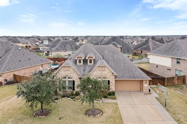 ranch-style house featuring a garage and a front yard