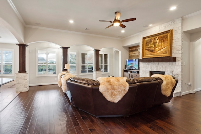 living room featuring dark hardwood / wood-style flooring, crown molding, and a fireplace