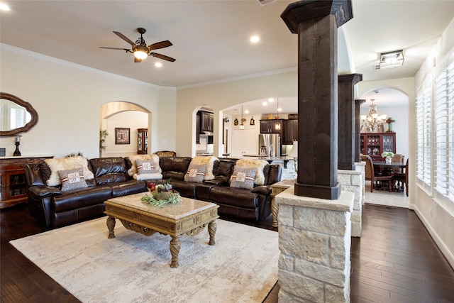 living room featuring ceiling fan with notable chandelier, dark hardwood / wood-style floors, and ornamental molding